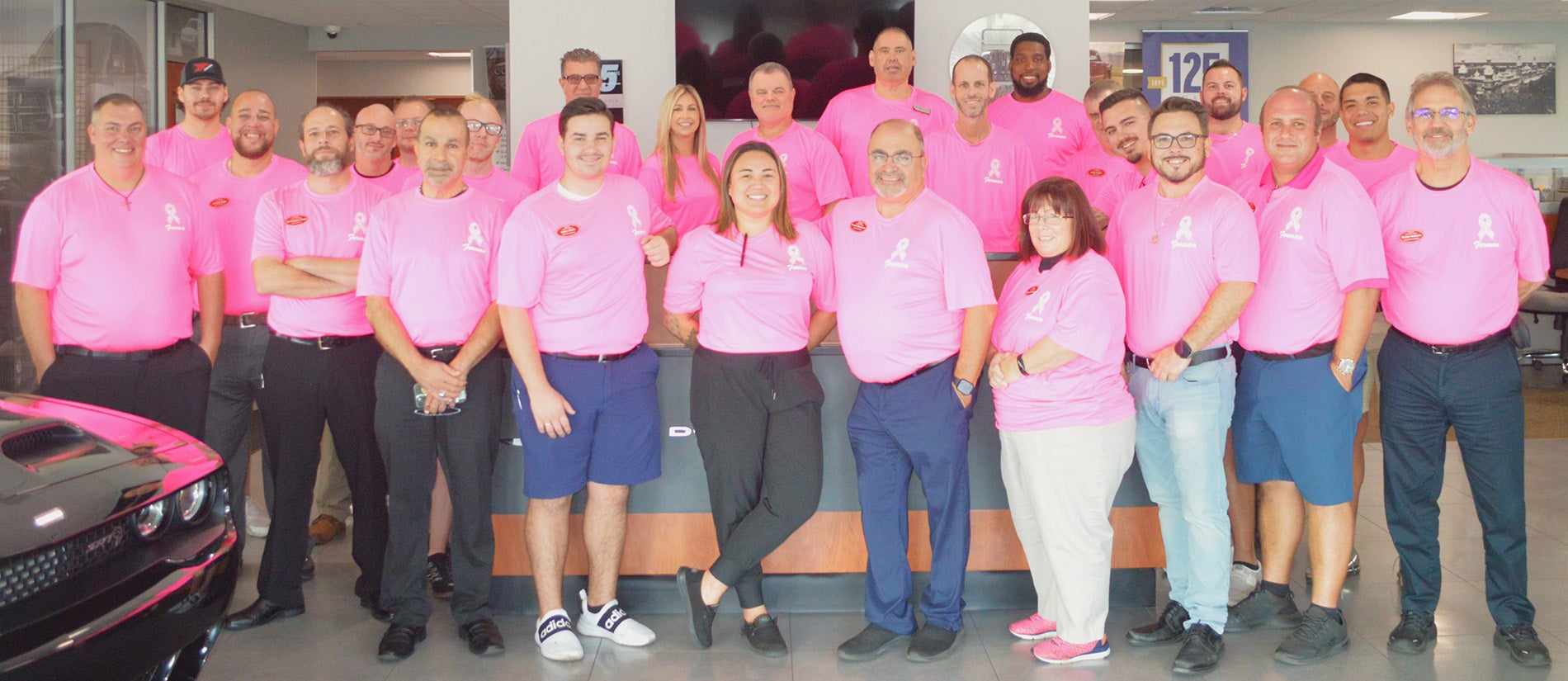 Ferman of New Port Richey Dealership Employee Photo all wearing Breast Cancer Awareness Pink Shirts